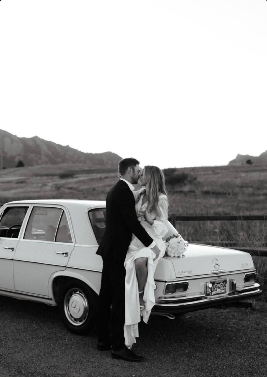 Couple kissing on blue Mustang