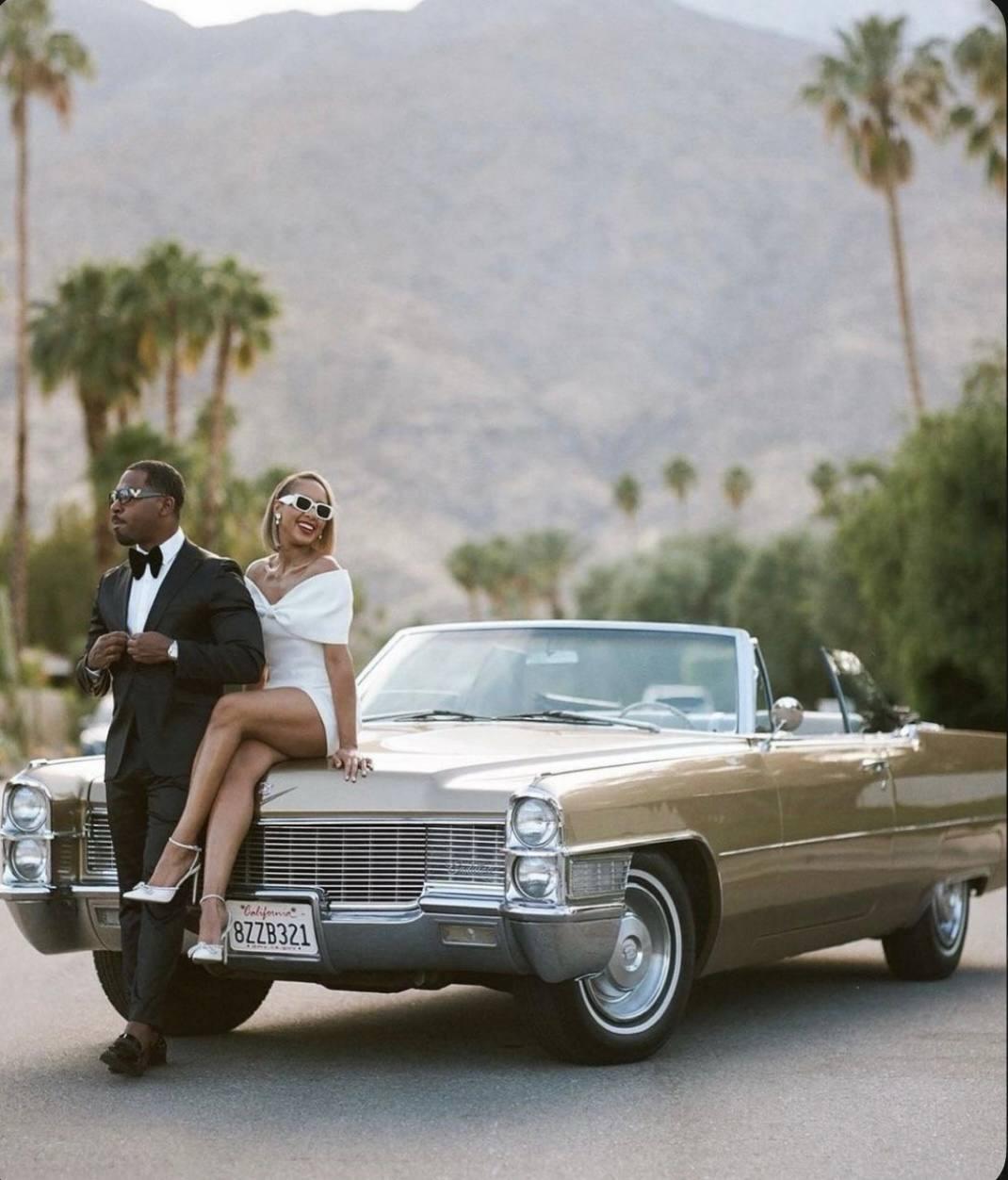 Bride dancing by vintage car