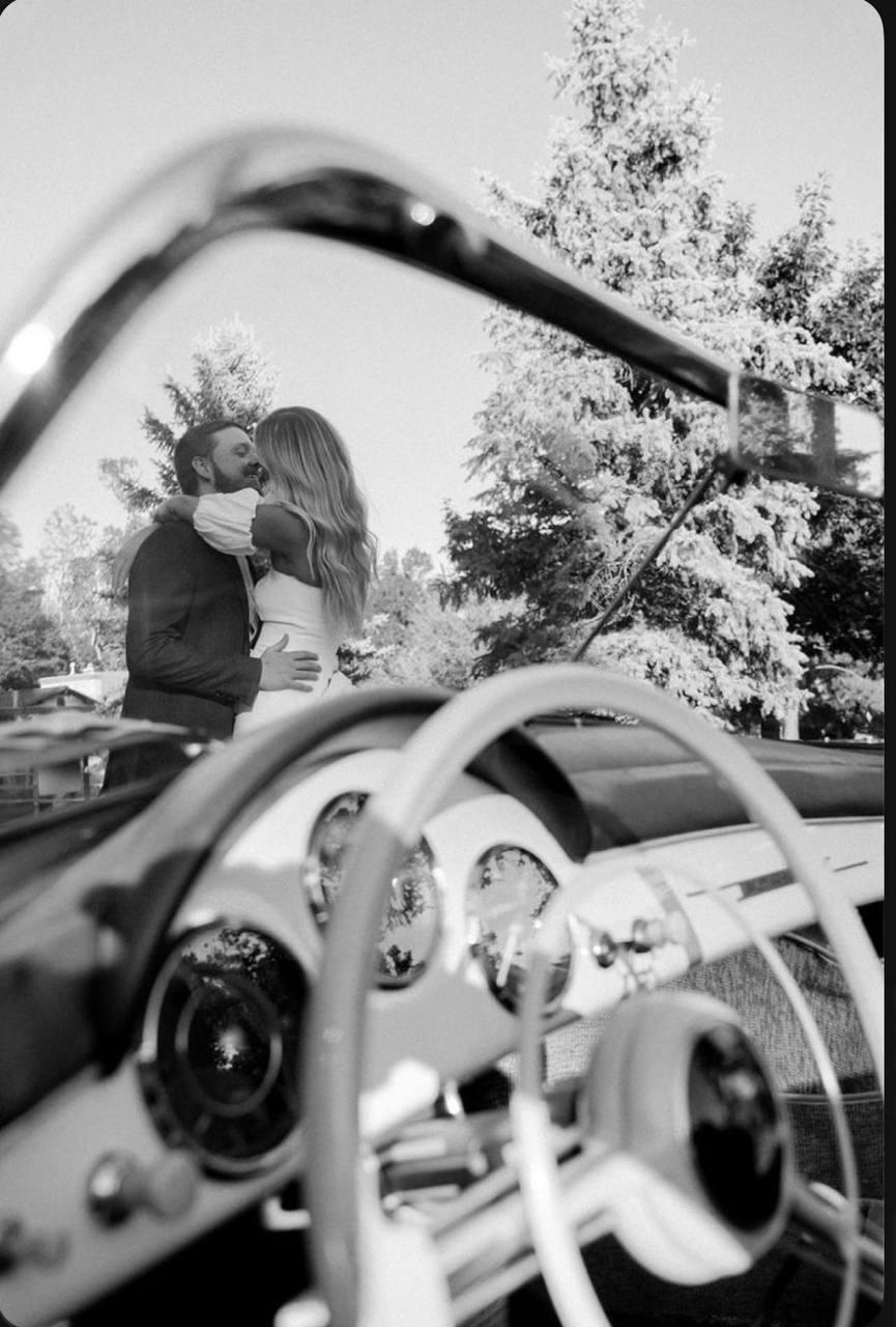 Couple kissing on blue Mustang